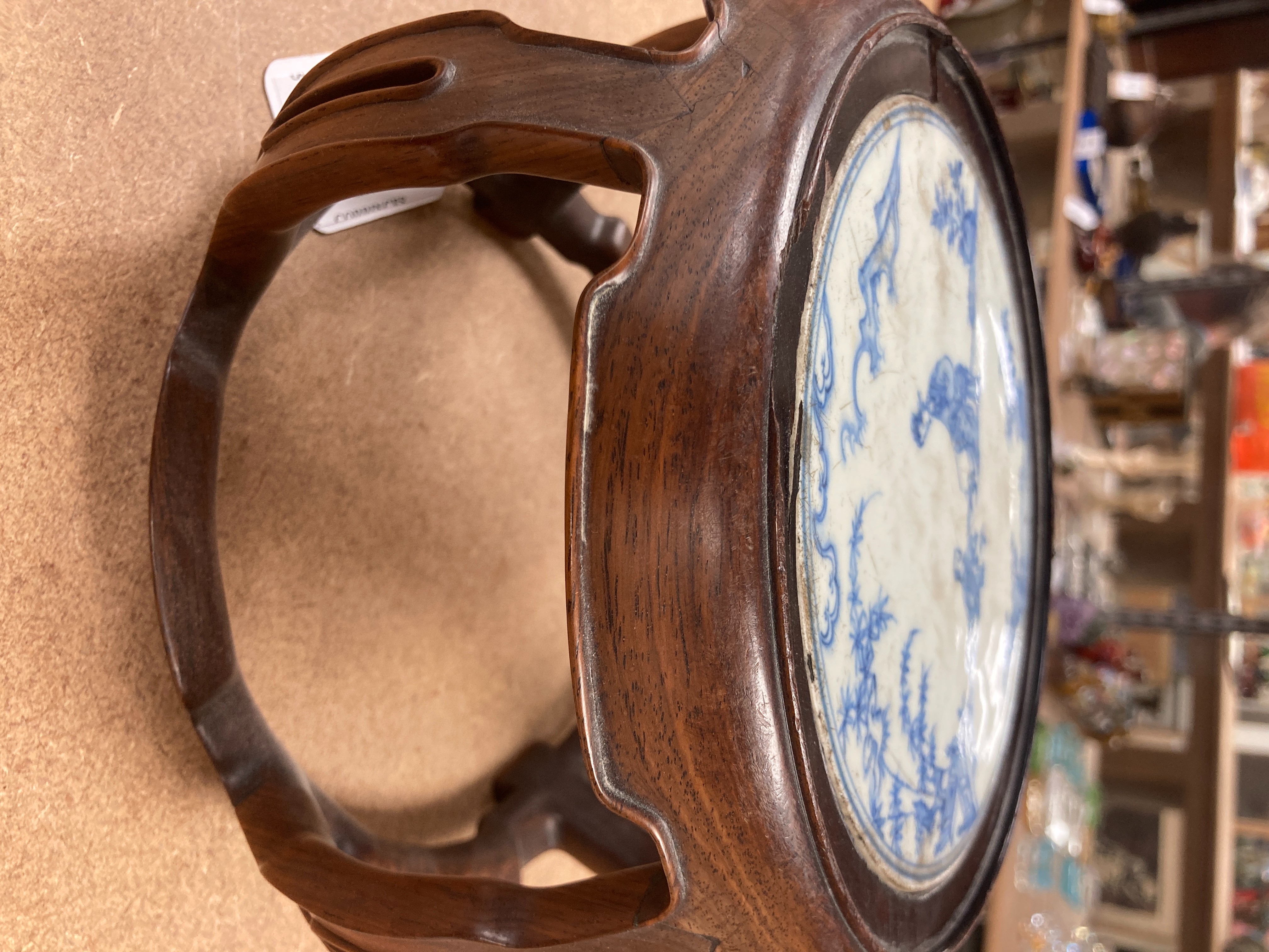 A 19th century Chinese blue and white circular tile inset hongmu stand, 22cm